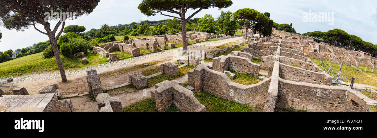 Panoramic view - 180 degree in the excavation ruins at Ostia Antica - from the Decumanus Maximus to the gym of Neptune thermal baths with the view of Stock Photo