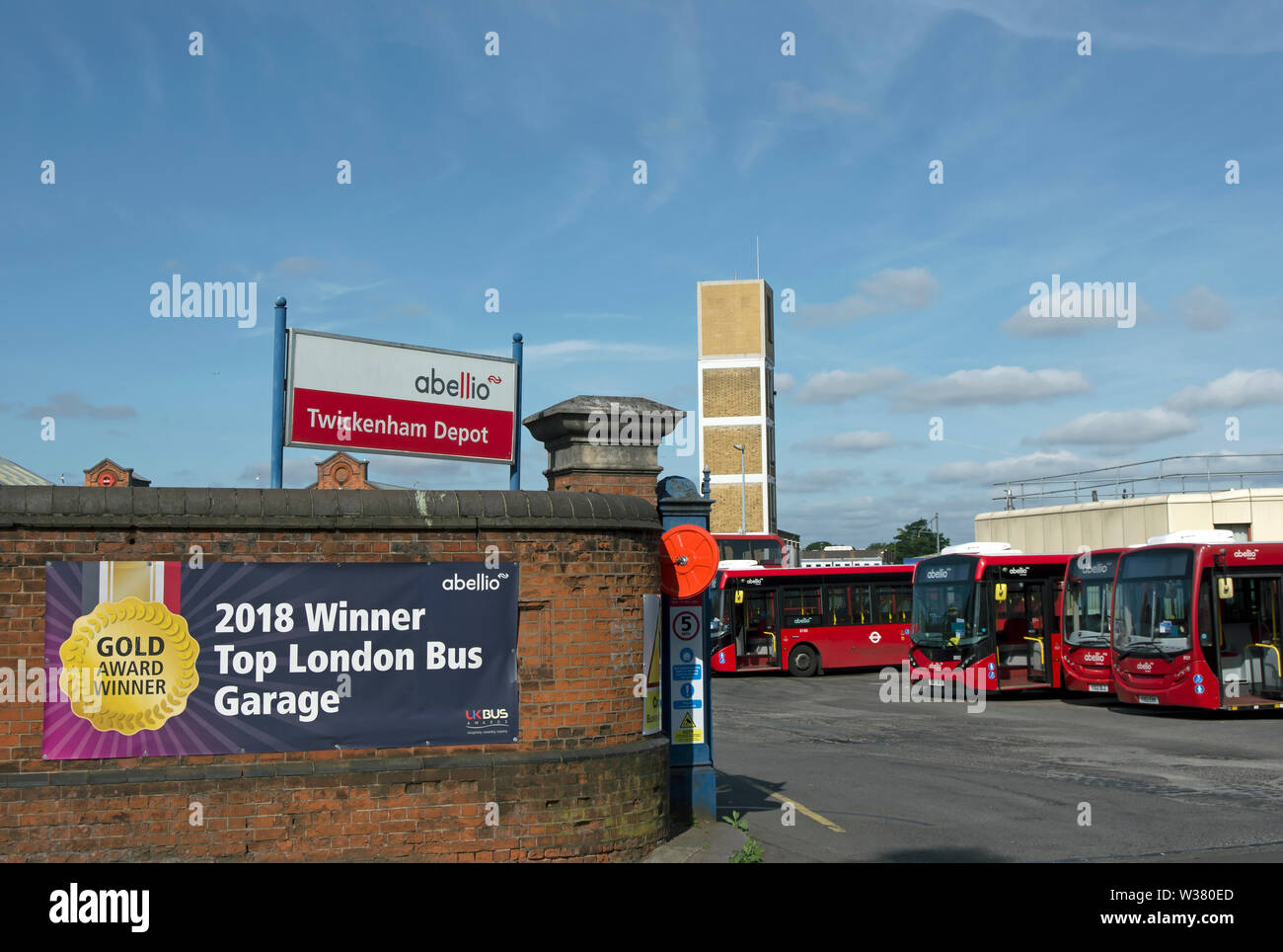 exterior of twickenham bus station with banner marking a 2018 award for best london bus garage
