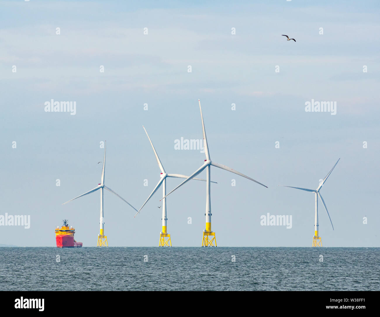 Offshore Wind Farm With Supply Ship High Resolution Stock