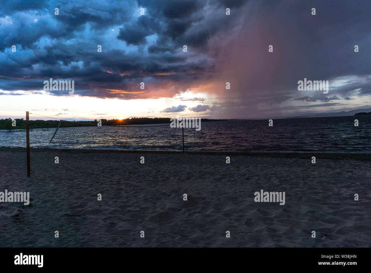 Sunset at Black Bear Beach/Petawawawa, in the distance a storm comes up , which approaches the beach fast and furiously. All people have gone Stock Photo