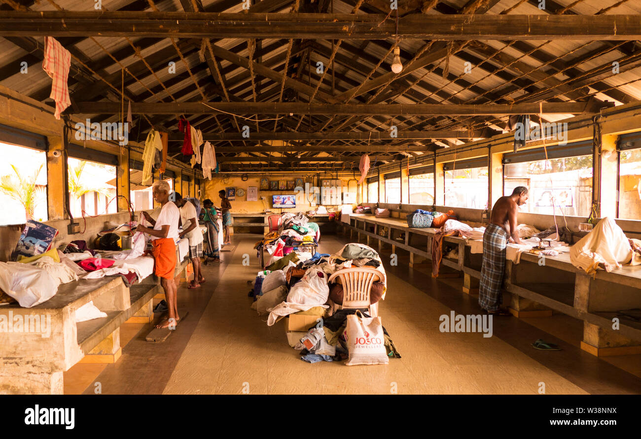 Traditional Local Indian Laundry Business with Traditional Indian Men and Women Workers in Kochi in Southern India. Stock Photo