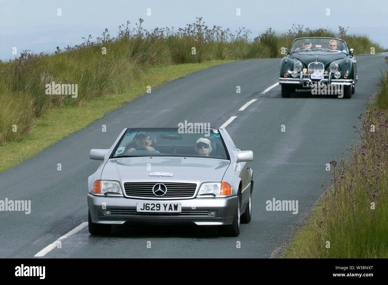 1992 90s nineties, Mercedes Benz 300Sl-24 Auto 300SL Catalytic Converter Auto Silver Car Roadster Petrol 2960 cc. Lancashire Automobile Club Coast to Coast rally route crosses the heights of the fantastic countryside in the Trough of Bowland with views over Morecambe Bay.  The event is open to classic and cherished heritage cars of all ages taking on the challenge of a route along some 170 miles of the byways and highways of rural England. Stock Photo