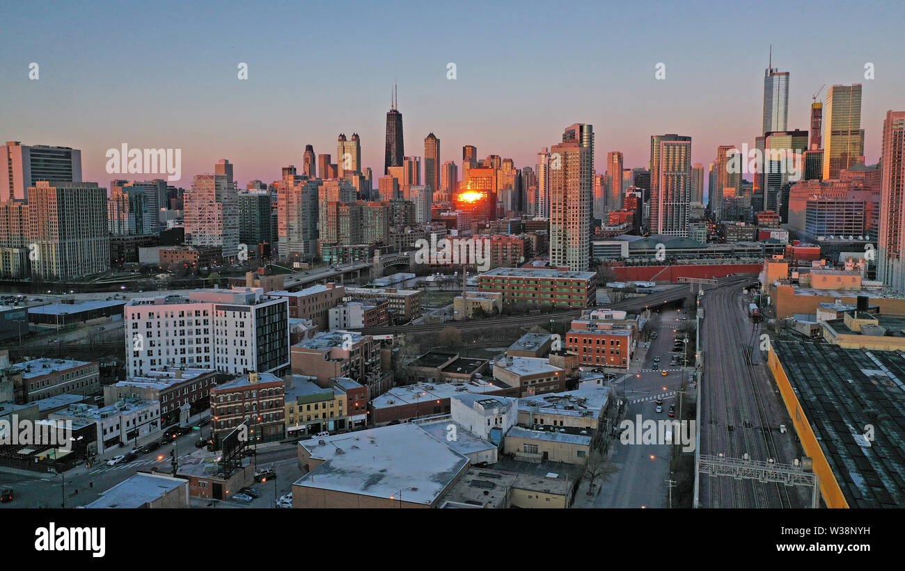 Bright orange light reflects off the buildings in downtown Chicago at sunset Stock Photo