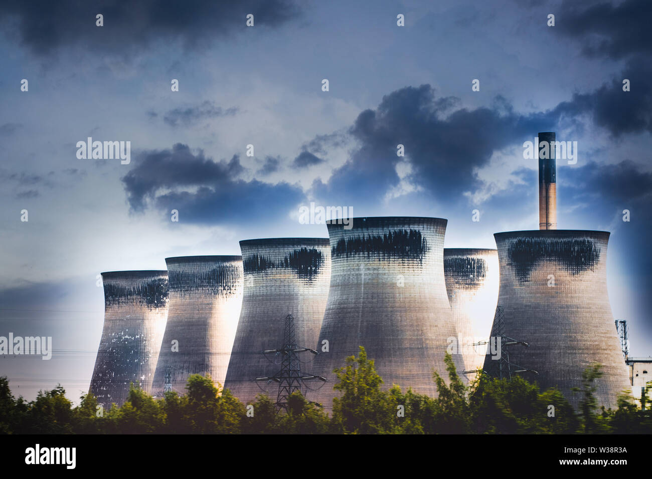 Energy Power Plant chimneys and cooling towers with dramatic sky. Polluting clean air showing climate change concepts...global warming Stock Photo