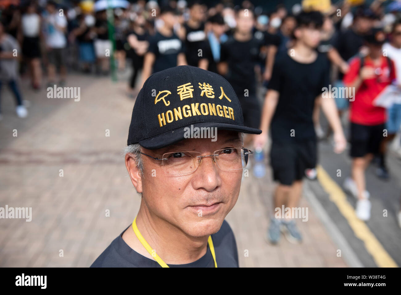 A protester wears a hat saying, Hongkonger, during the rally.Thousands of protesters took to the streets of the Sheung Shui district in northern Hong Kong in an anti-parallel trading march. Some protesters clashed with the police after the march. Numbers of protesters are reported to be injured. Stock Photo