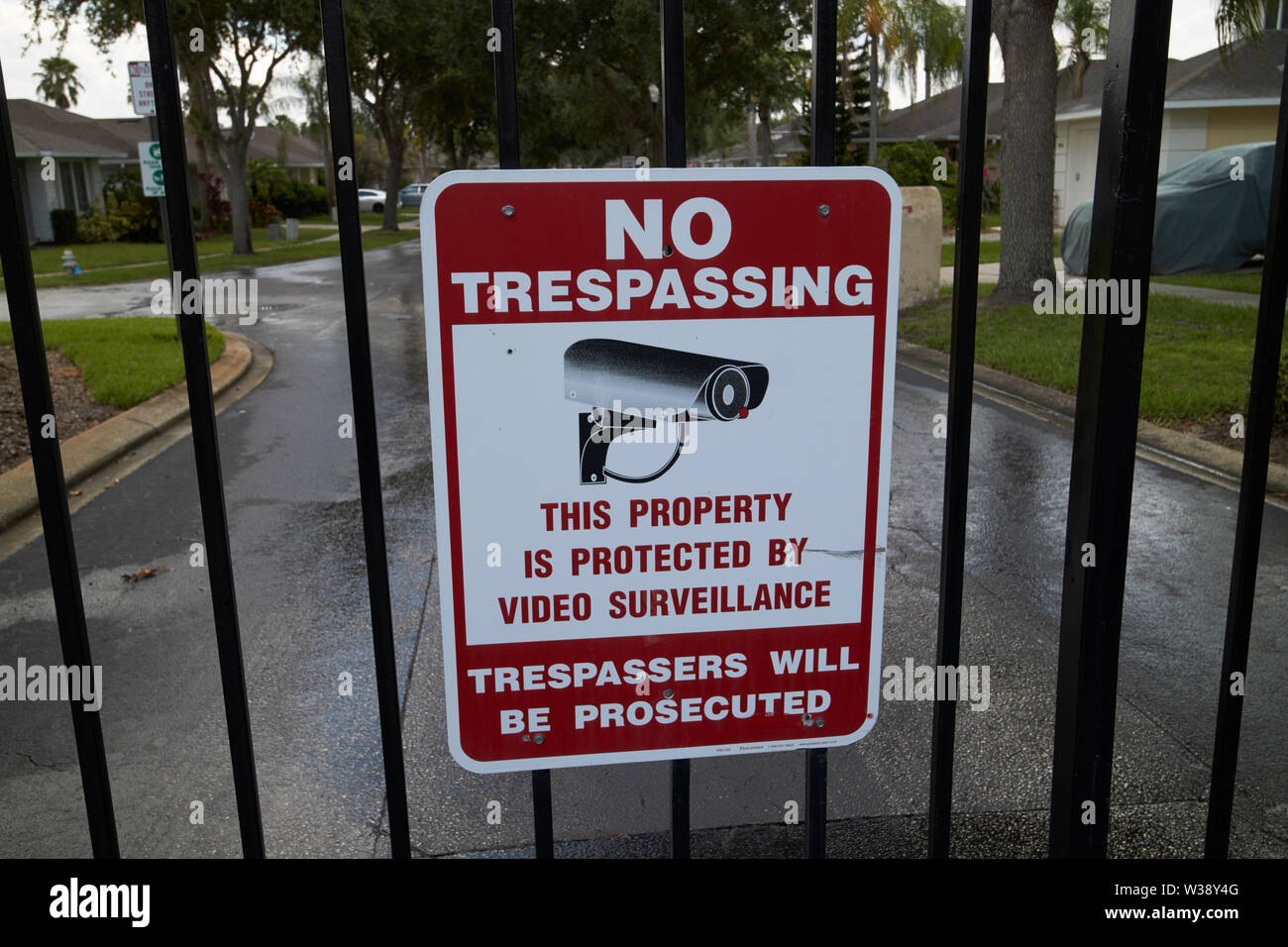 no trespassing sign on the gates of a residential gated community in florida USA United States of America Stock Photo