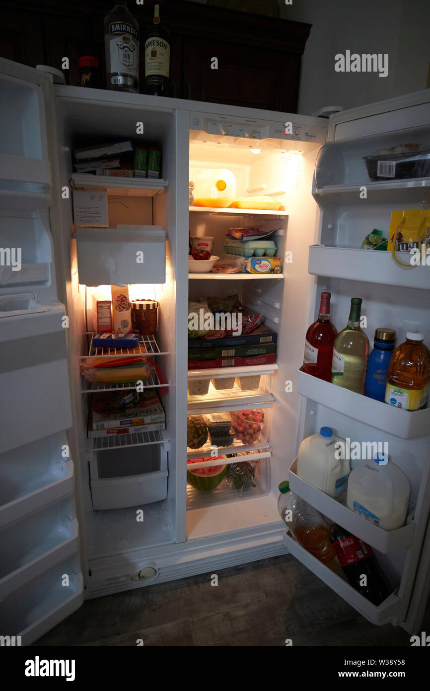 doors open of a well stocked large us kitchen fridge freezer USA United States of America Stock Photo