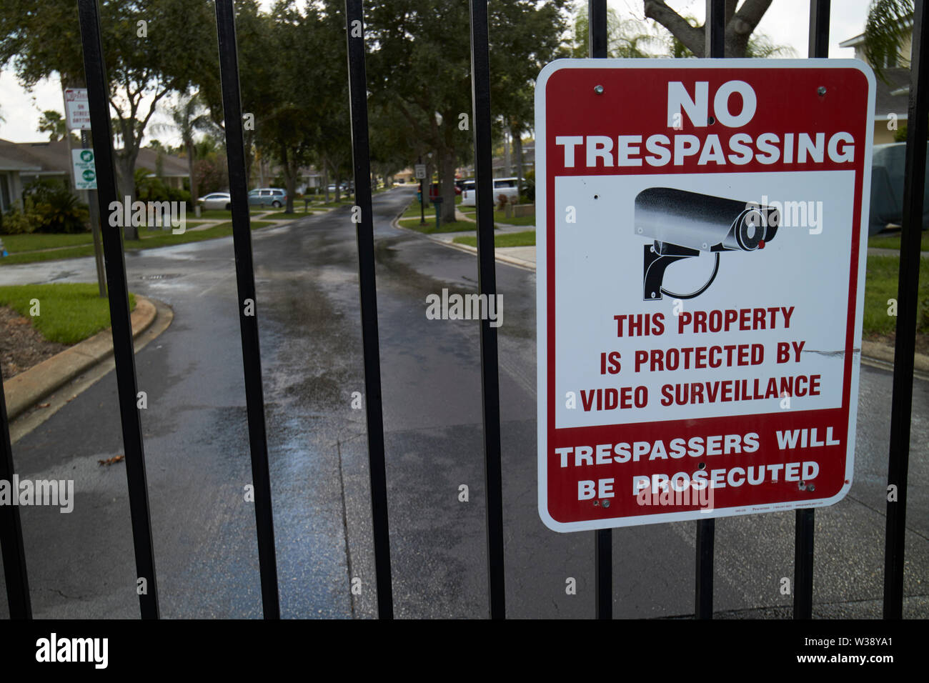 no trespassing sign on the gates of a residential gated community in florida USA United States of America Stock Photo
