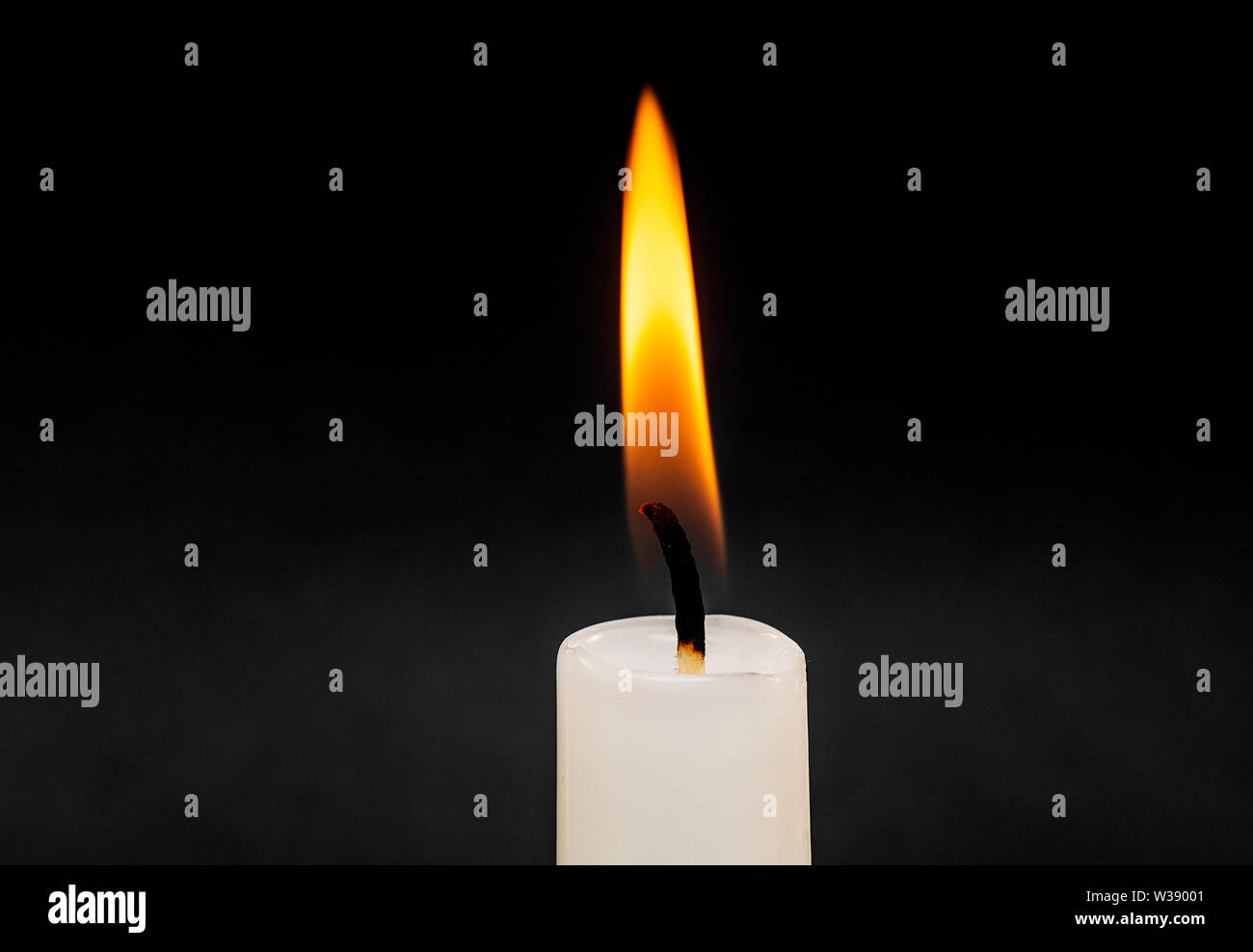 Candle Flame Fire isolated on Black Background with Soft Smoke Stock Photo