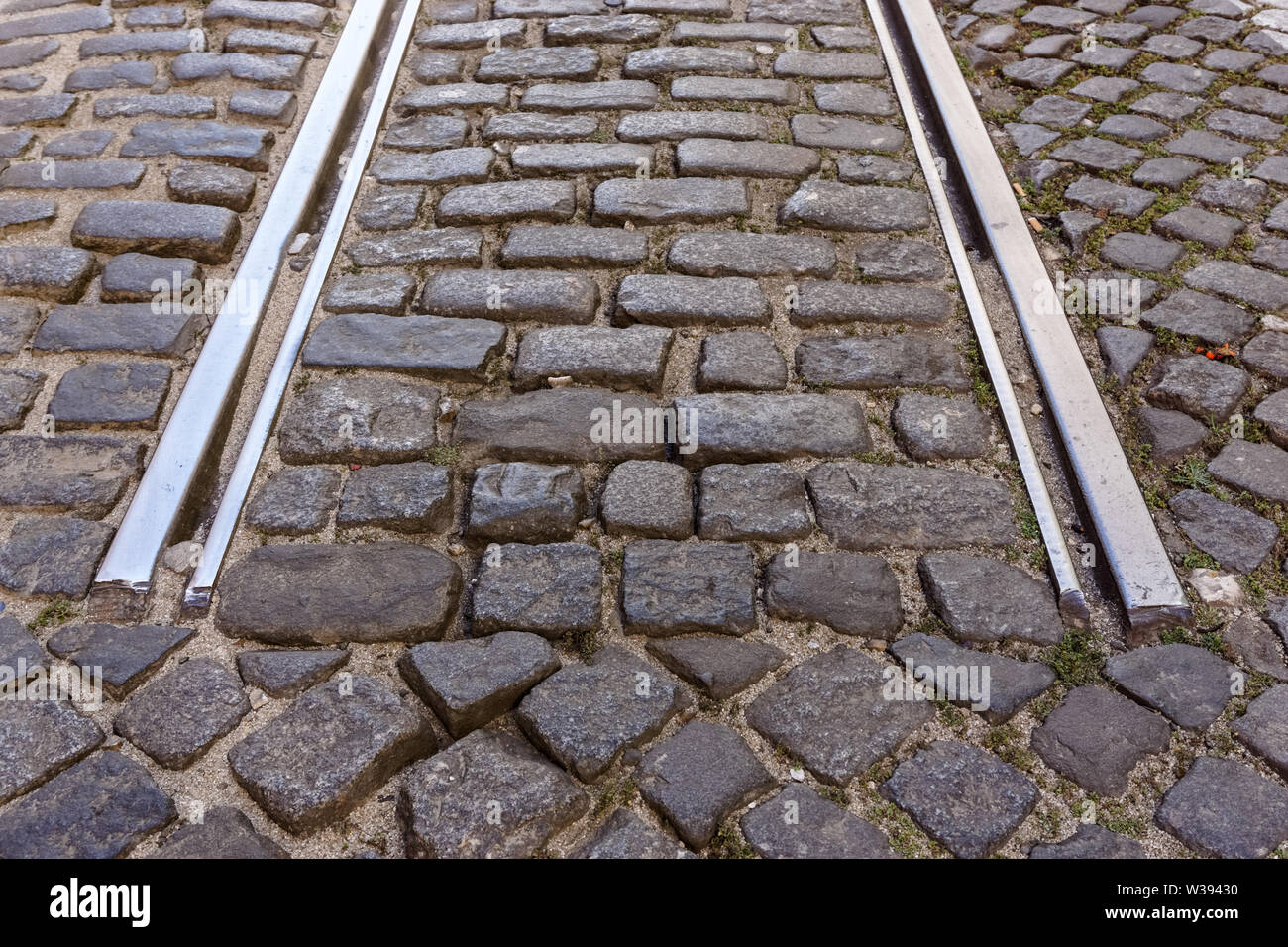 Dead end of tram tracks on cobbled street in the Alfama District, Lisbon, Portugal Stock Photo