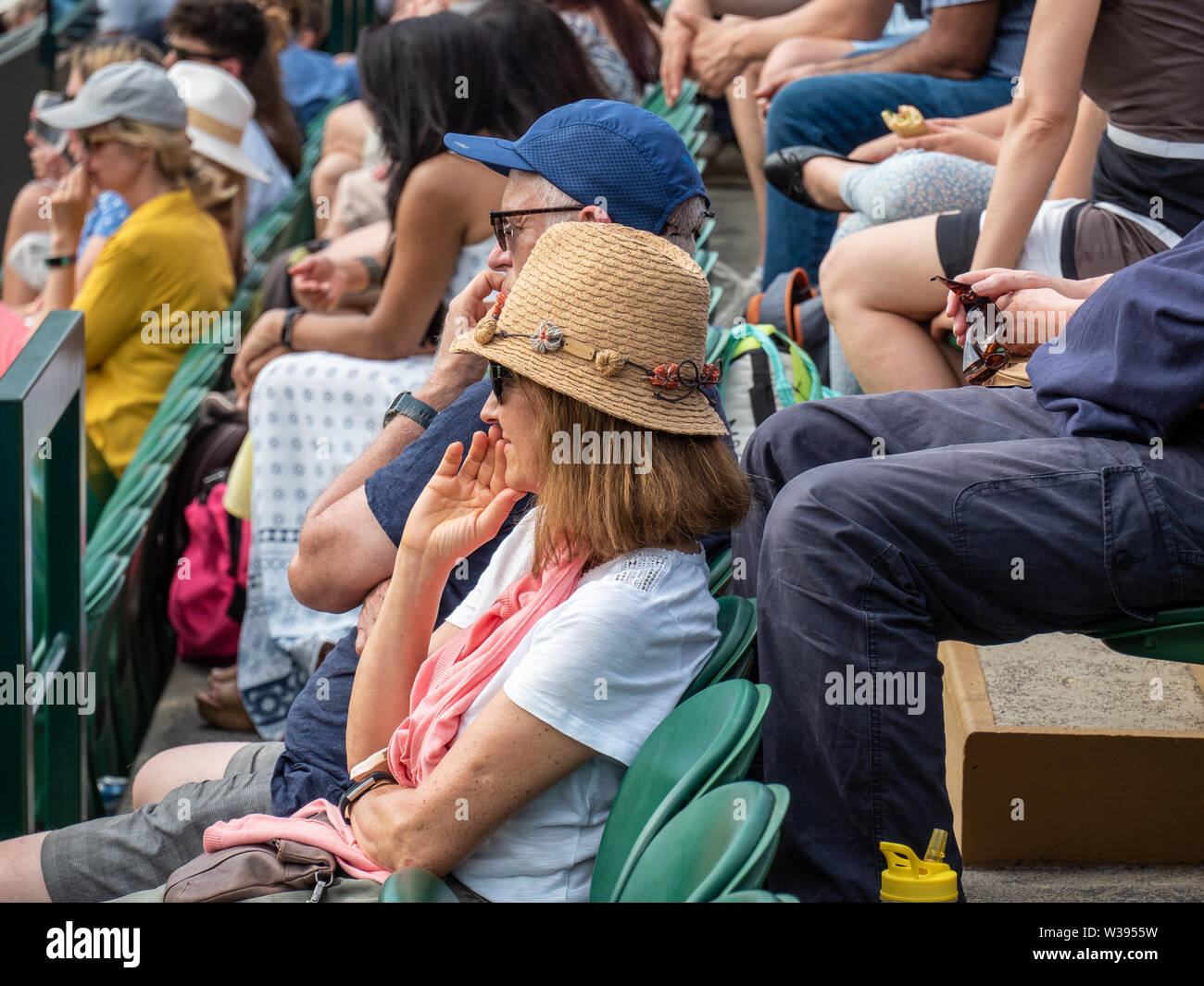 Spectator with a pretty hat at a Wimbledon Tennis Tournament, London, England Stock Photo