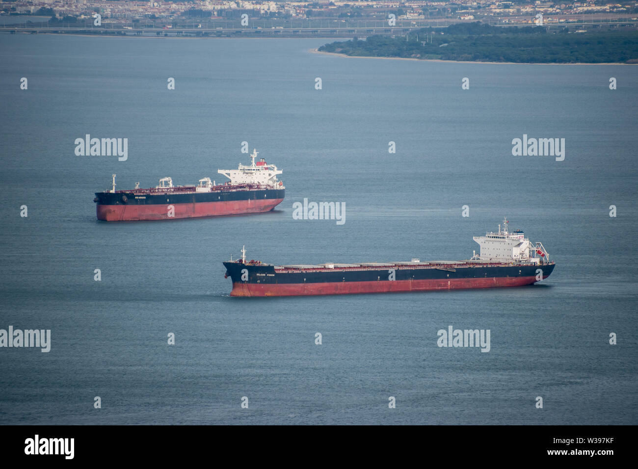 Two large freighter ships sailing through the straight of Gibraltar, UK Stock Photo