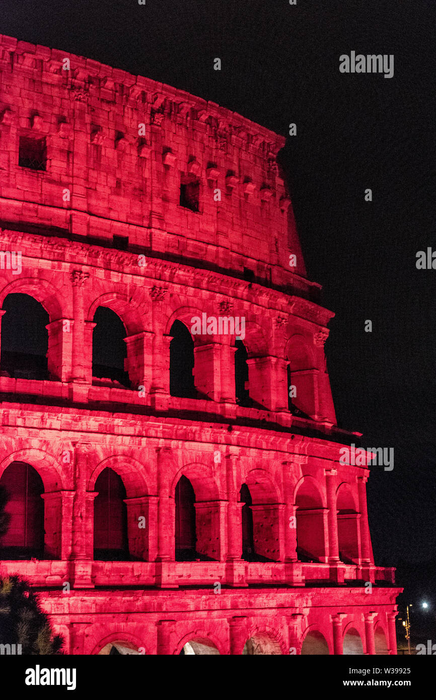 The Colosseum lit red for persecuted Christians in Rome, Italy Stock Photo