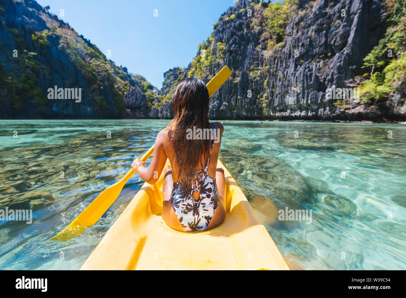 Woman Kayaking In The Small Lagoon In El Nido Palawan Woman Kayaking In The Small Lagoon In El Nido Palawan