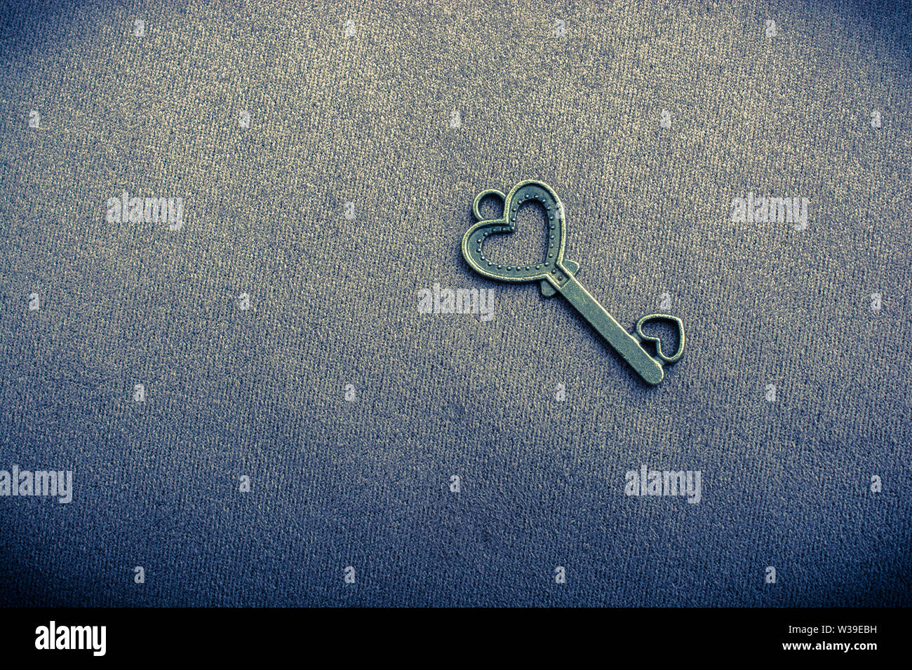 Heart shaped retro metal key on plain background Stock Photo - Alamy