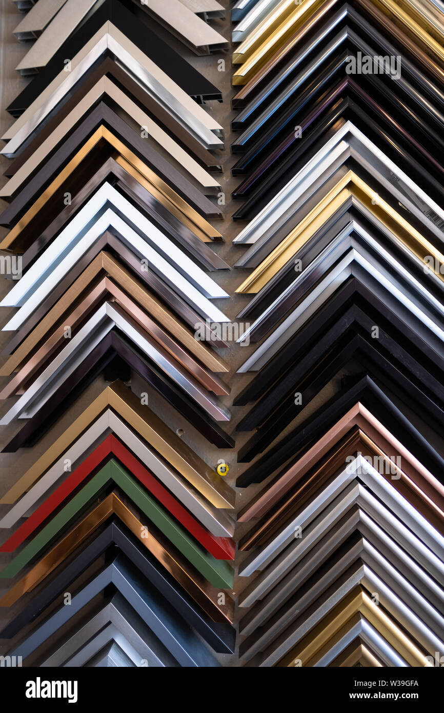 Rows of sample picture frames in a custom picture framing shop Stock