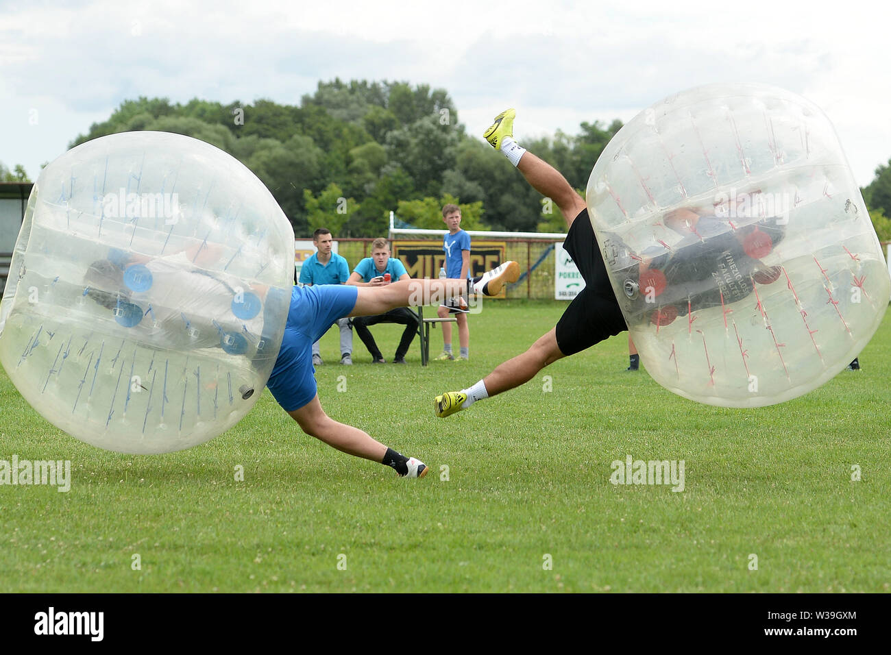 Vratisinec, Croatia. 13th July, 2019. People play Bubble Football, a recreational sport similar to zorb, in Vratisinec village of Medimurje County, Croatia, on July 13, 2019. Credit: Vjeran Zganec Rogulja/Xinhua/Alamy Live News Stock Photo