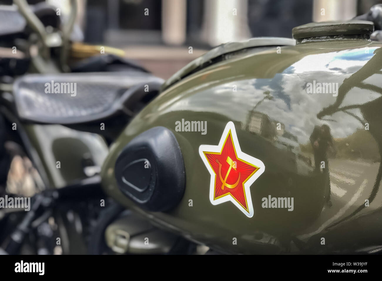 Soviet star and hammer and sickle on the gas tank of the Soviet motorcycle URAL, close-up. Stock Photo
