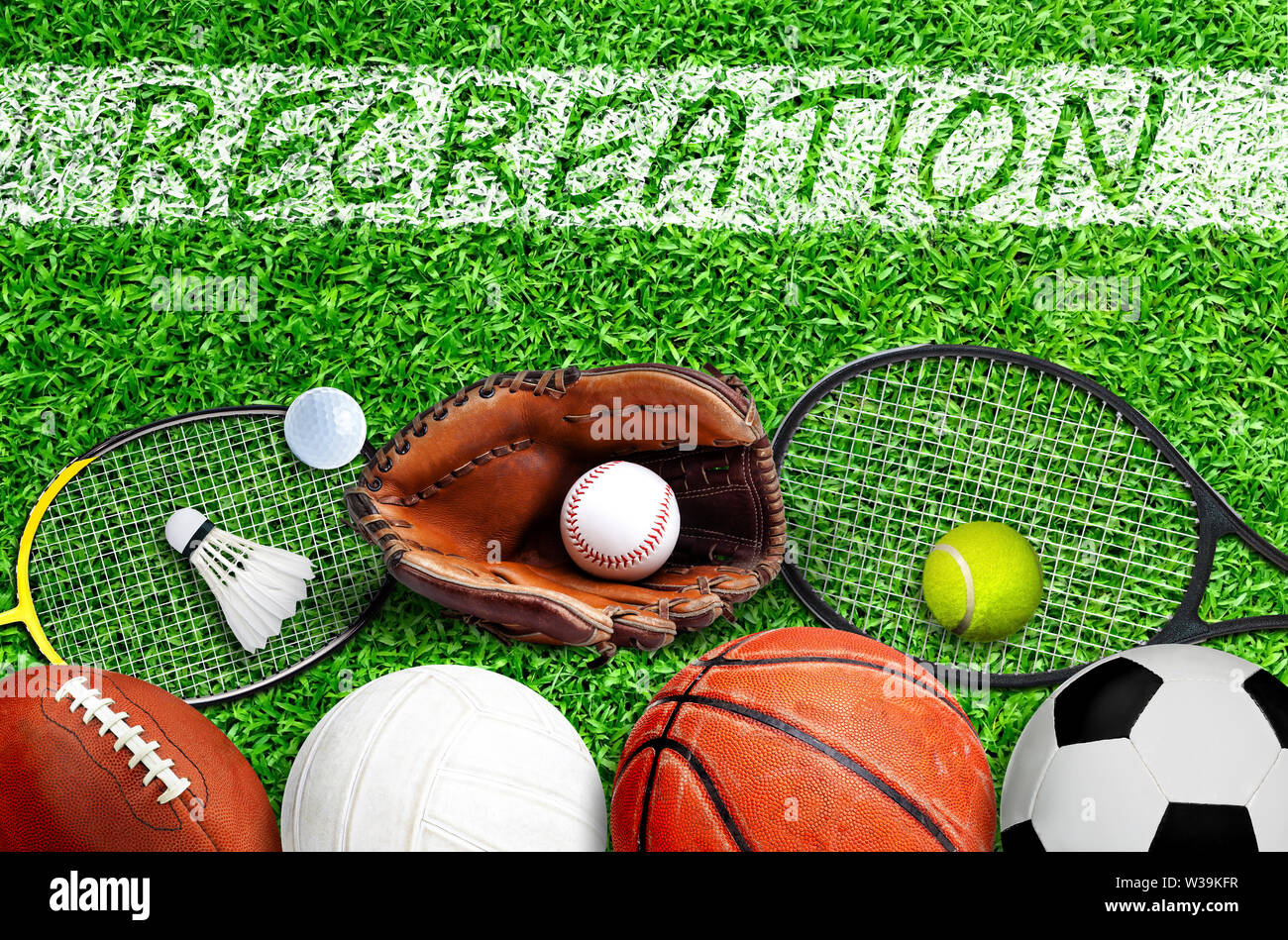 Top down view of popular sports equipment on field with RECREATION text painted on line marking