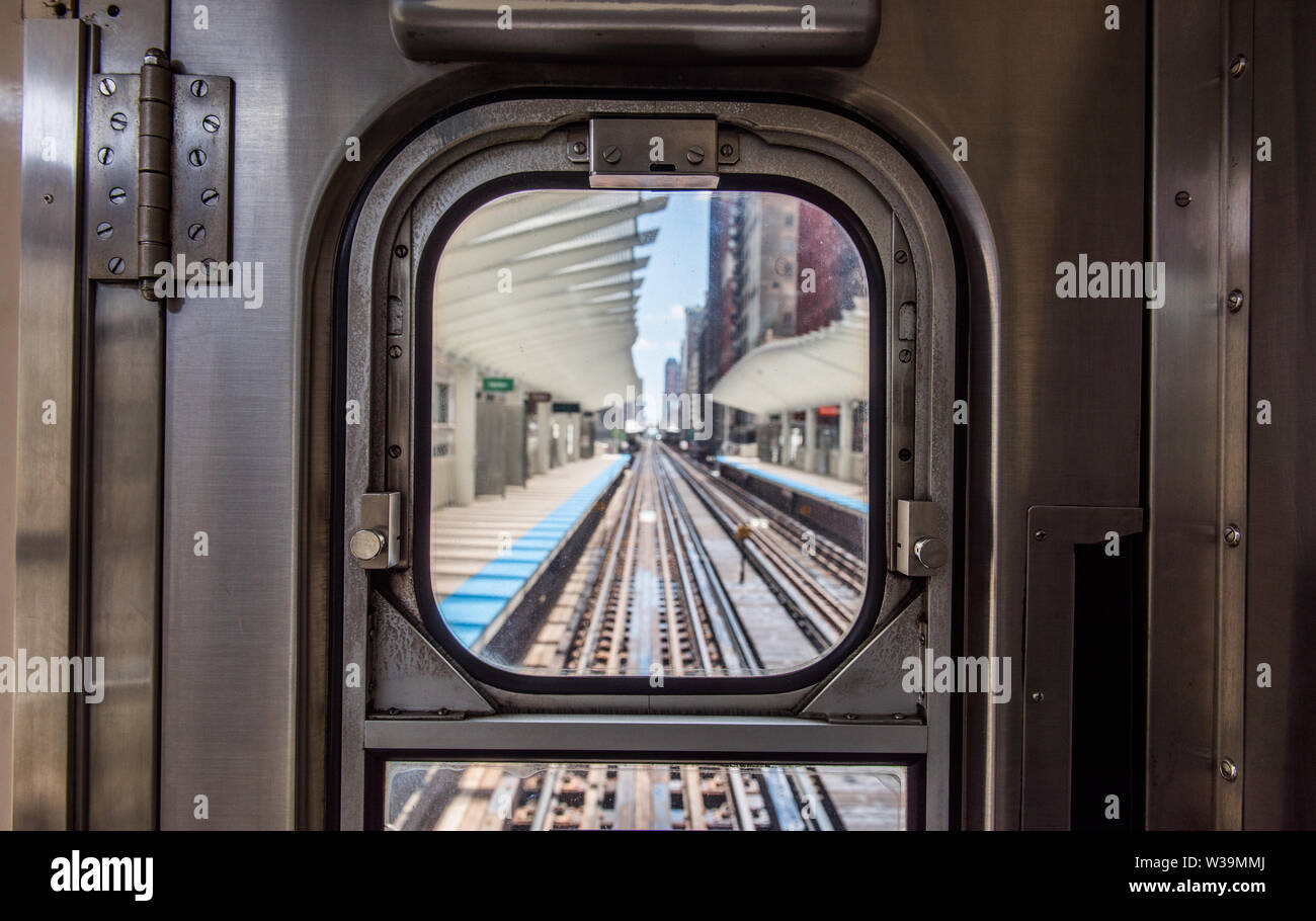 view of Washington/Wabash station through the window at the back of a Chicago EL train. Stock Photo