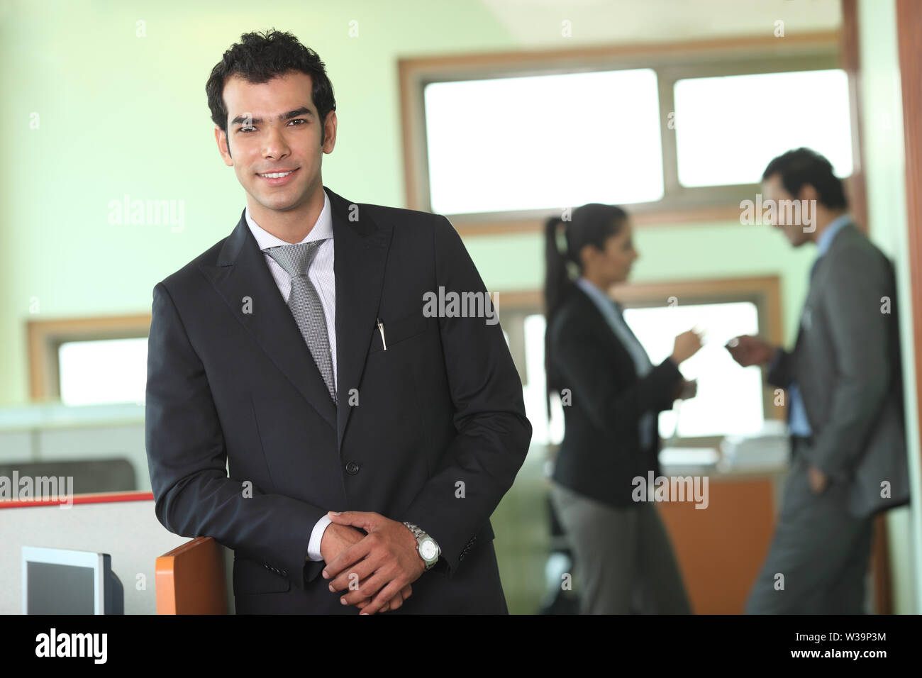 Portrait of a businessman smiling in an office Stock Photo - Alamy