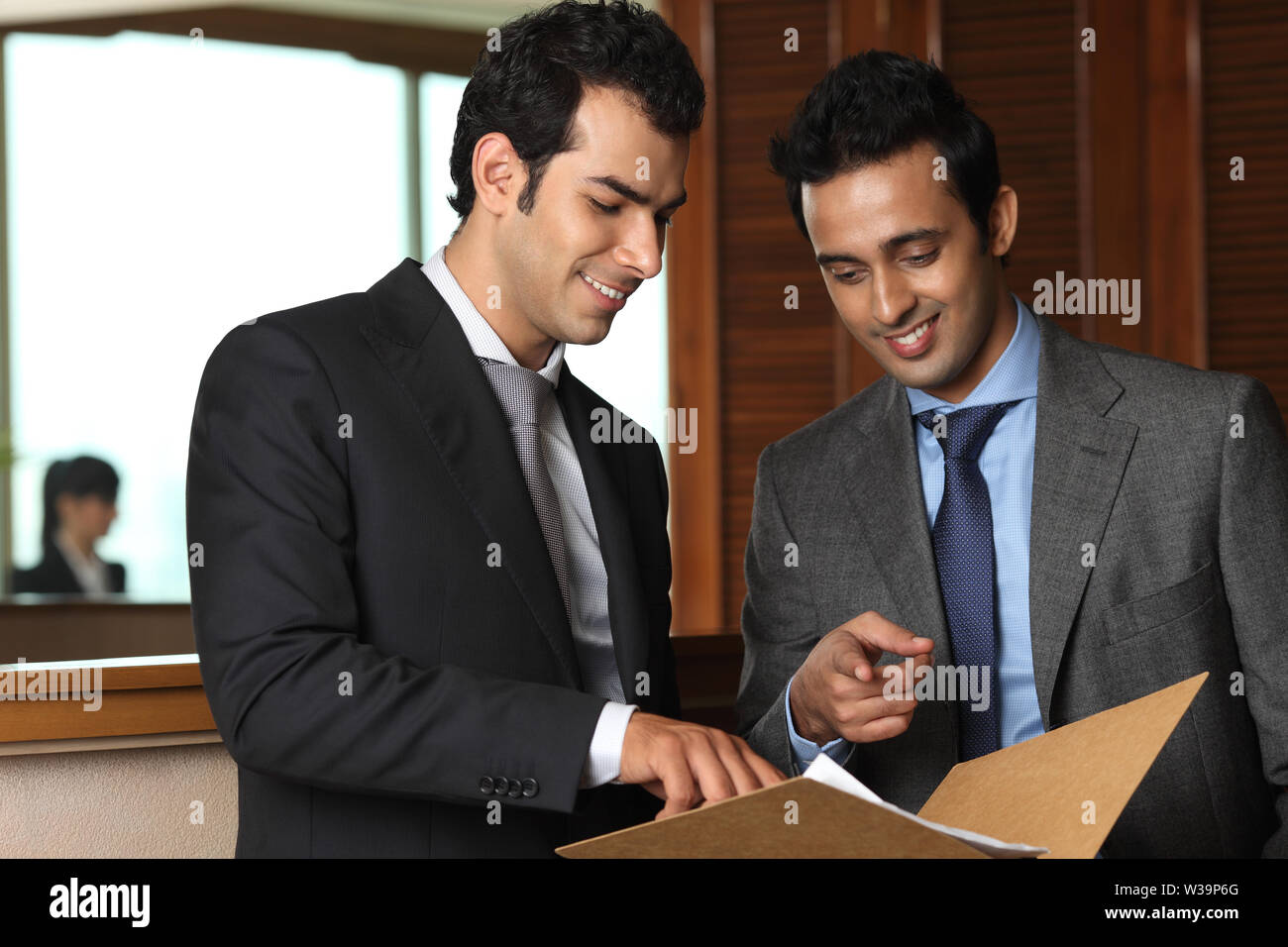 Two businessmen discussing documents in office Stock Photo