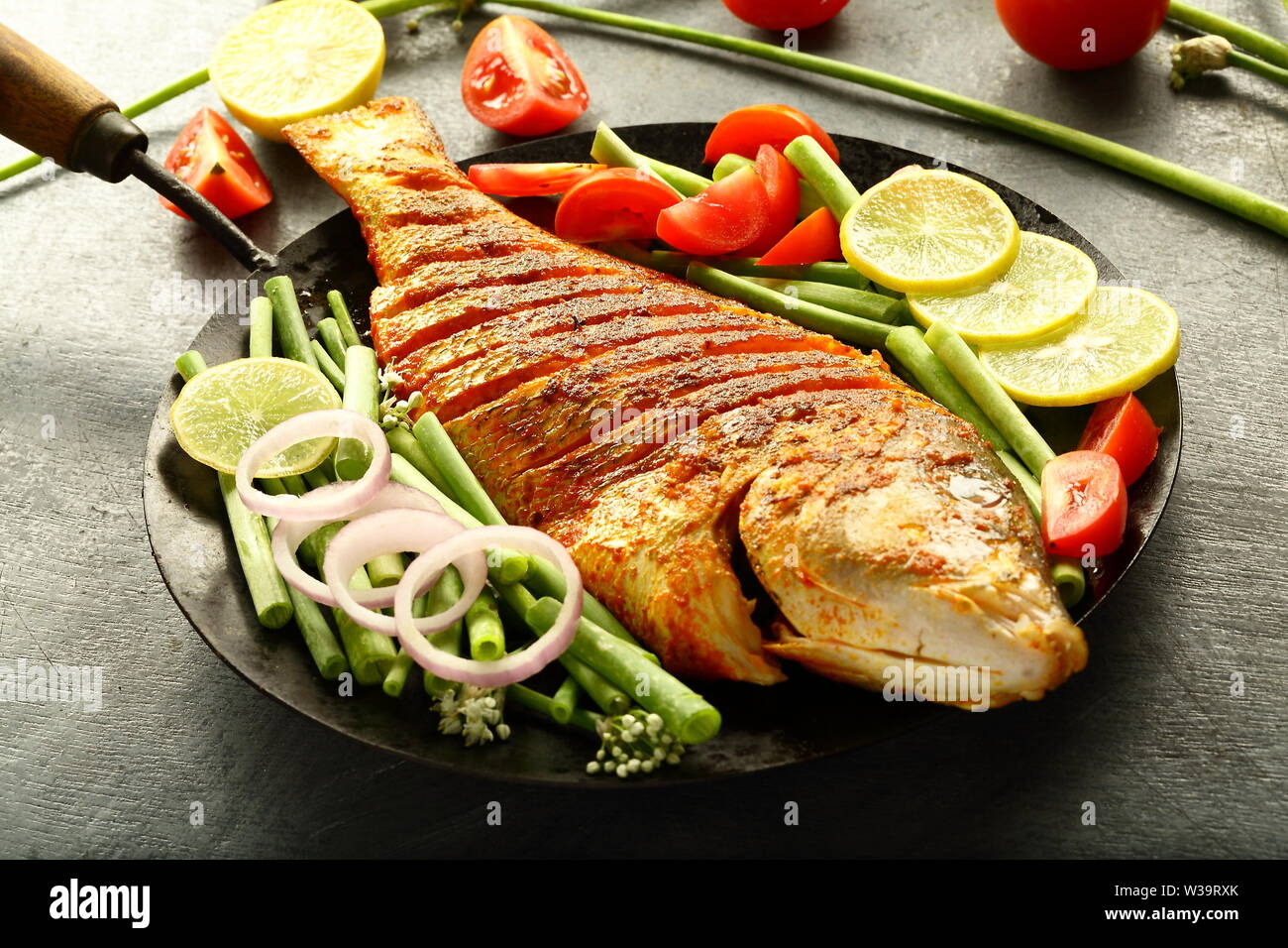 Spicy roasted fish with green salad - Healthy meal concepts Stock Photo