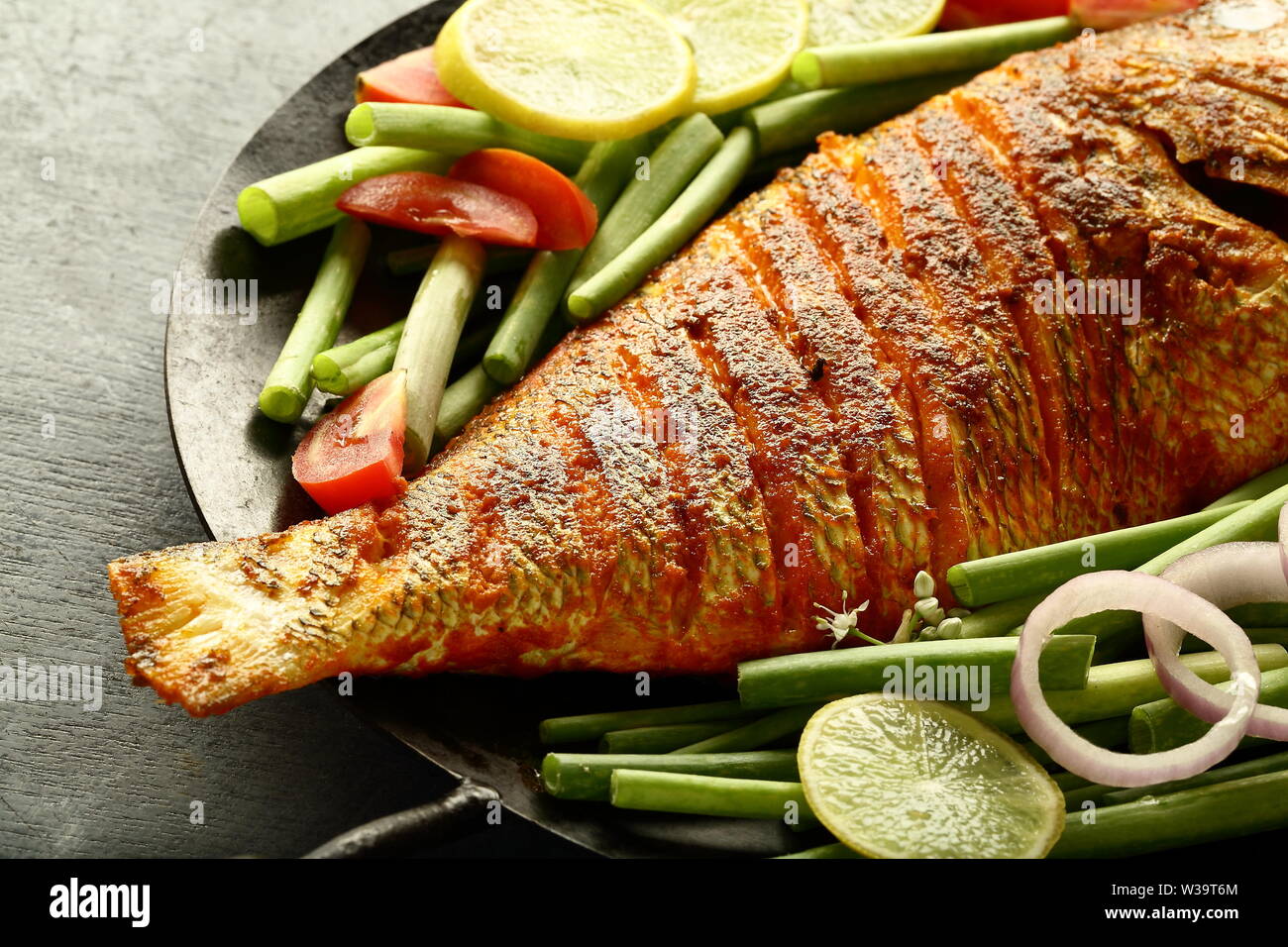 Fresh fried fish served with green salad Stock Photo - Alamy