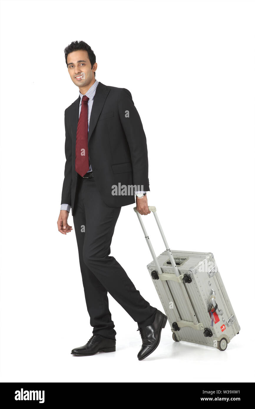 Businessman walking with suitcase Stock Photo Alamy