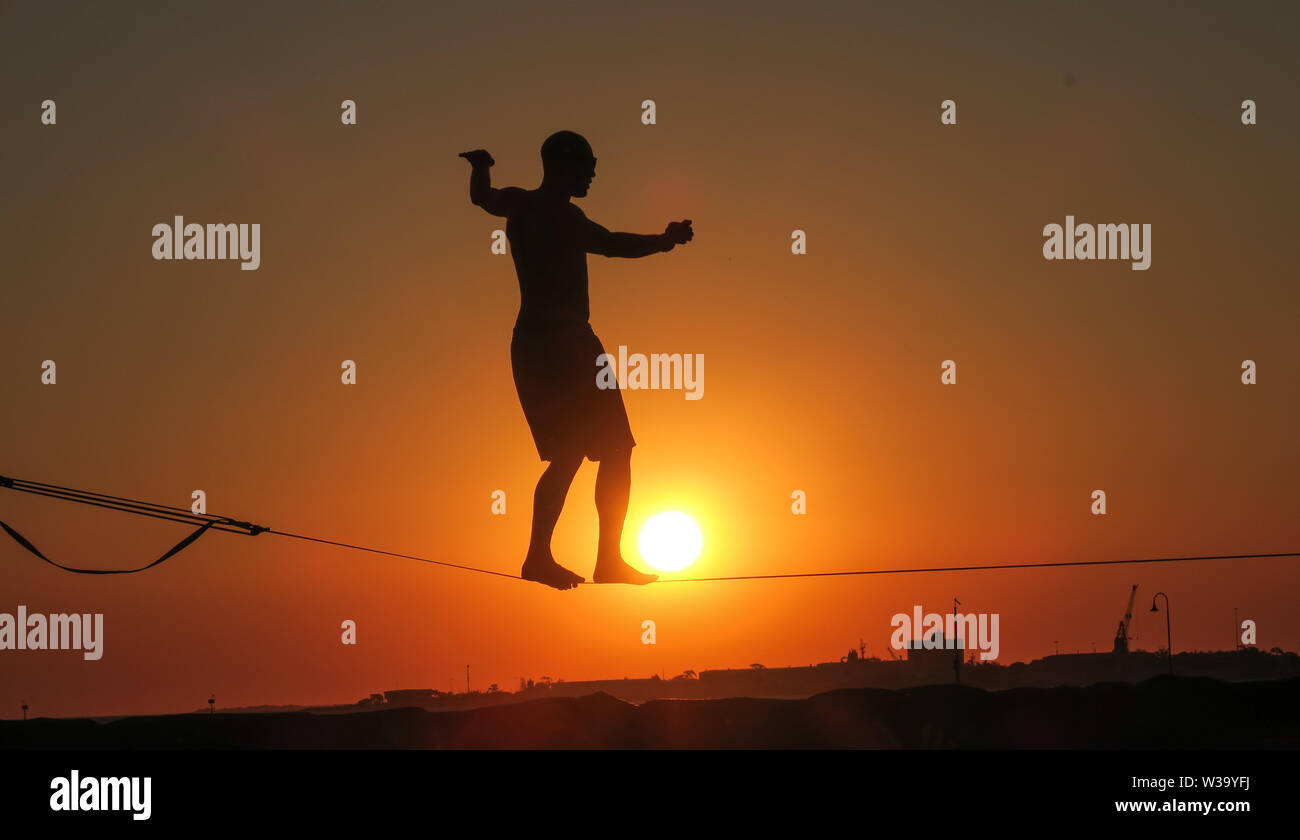 Balanced on the tightrope at sunset in Melbourne Australia. Stock Photo