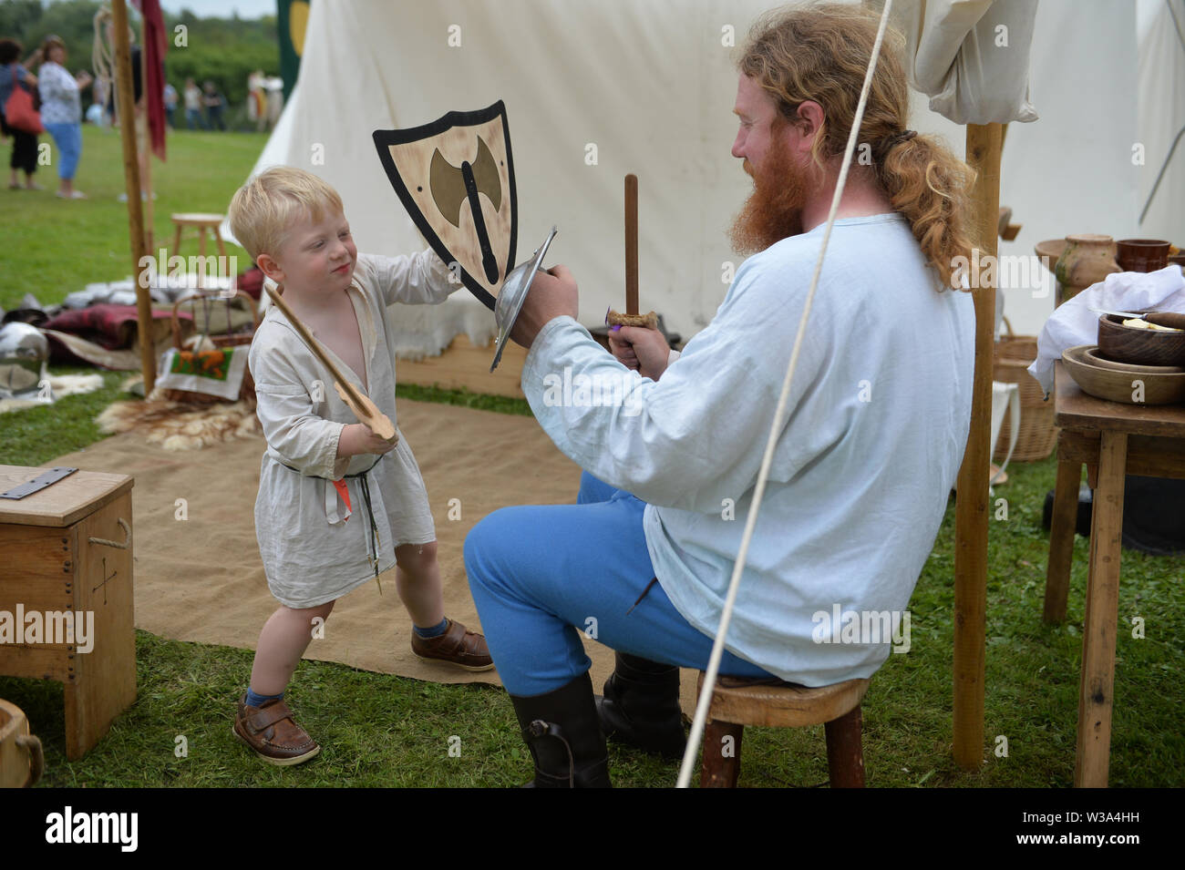 Medieval re-renactors attend the Tewkesbury Medieval Festival at Tewkesbury Battlefield in Gloucestershire. Stock Photo