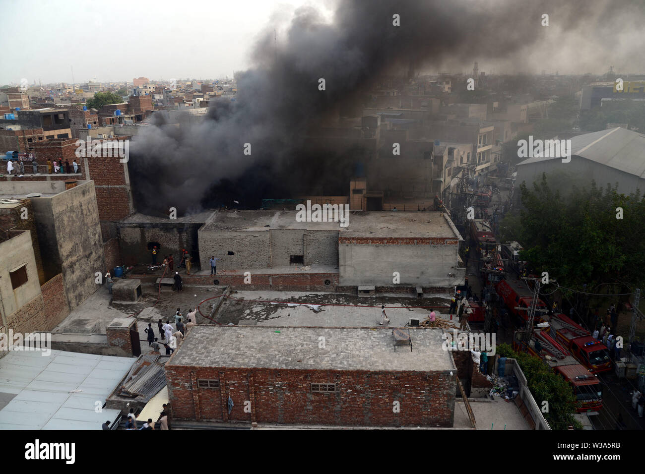 Lahore, Pakistan. 13th July, 2019. A view of erupted smoke as Rescue