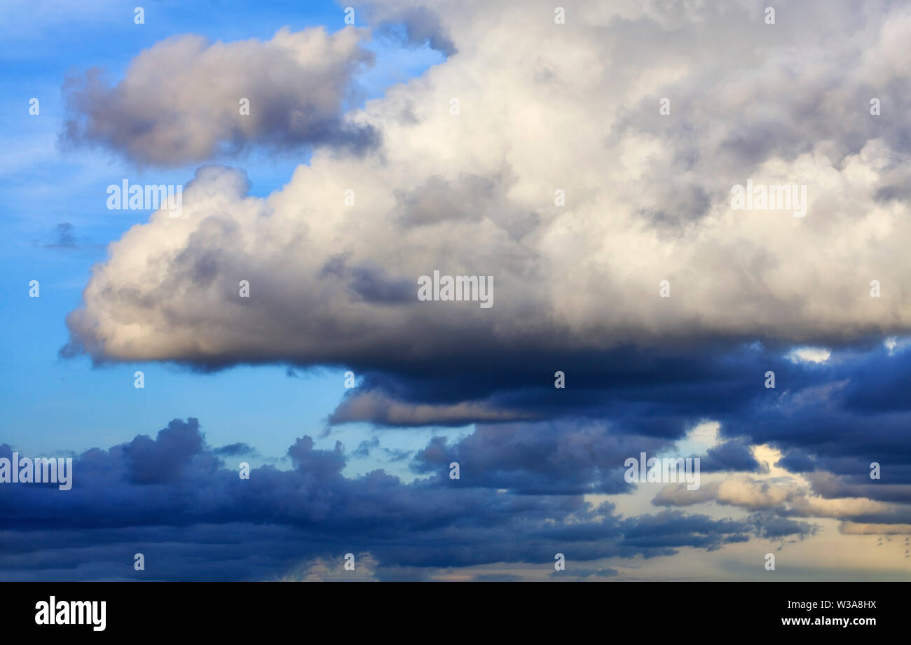 Thunderclouds float in the sky, gathering together. Stock Photo
