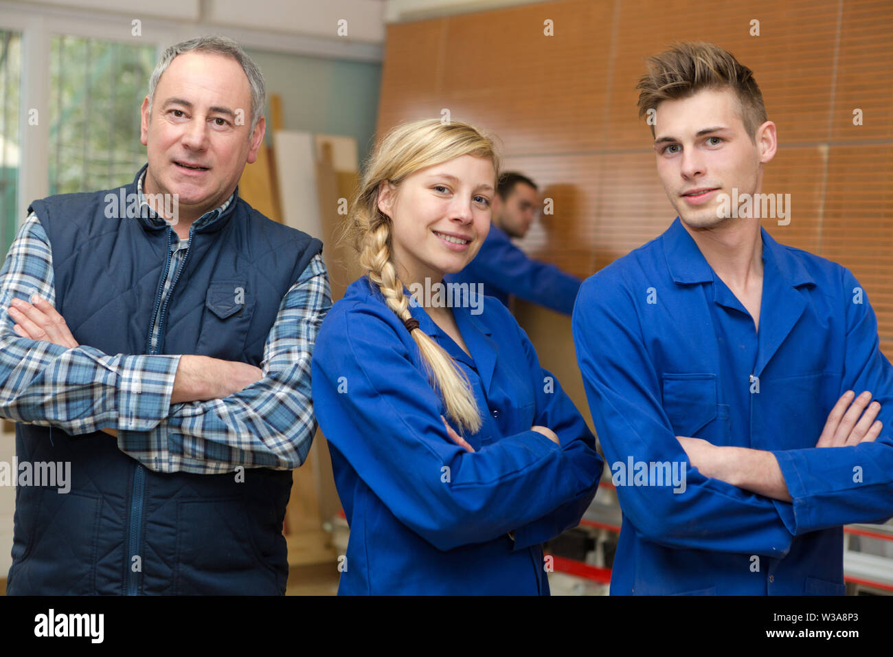 carpenter with students in workshop Stock Photo