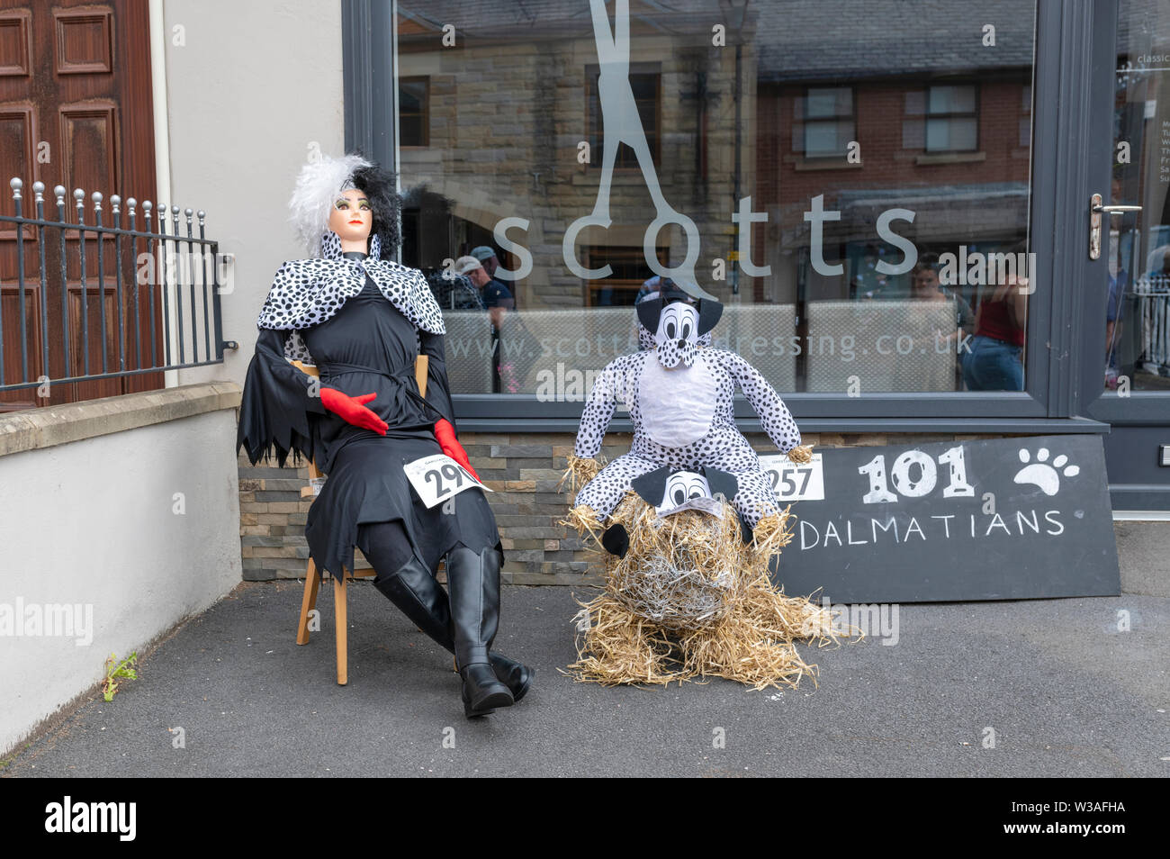An exhibit at the Garstang Scarecrow Festival. Cruella De Vil and a Dalmatian dog Stock Photo