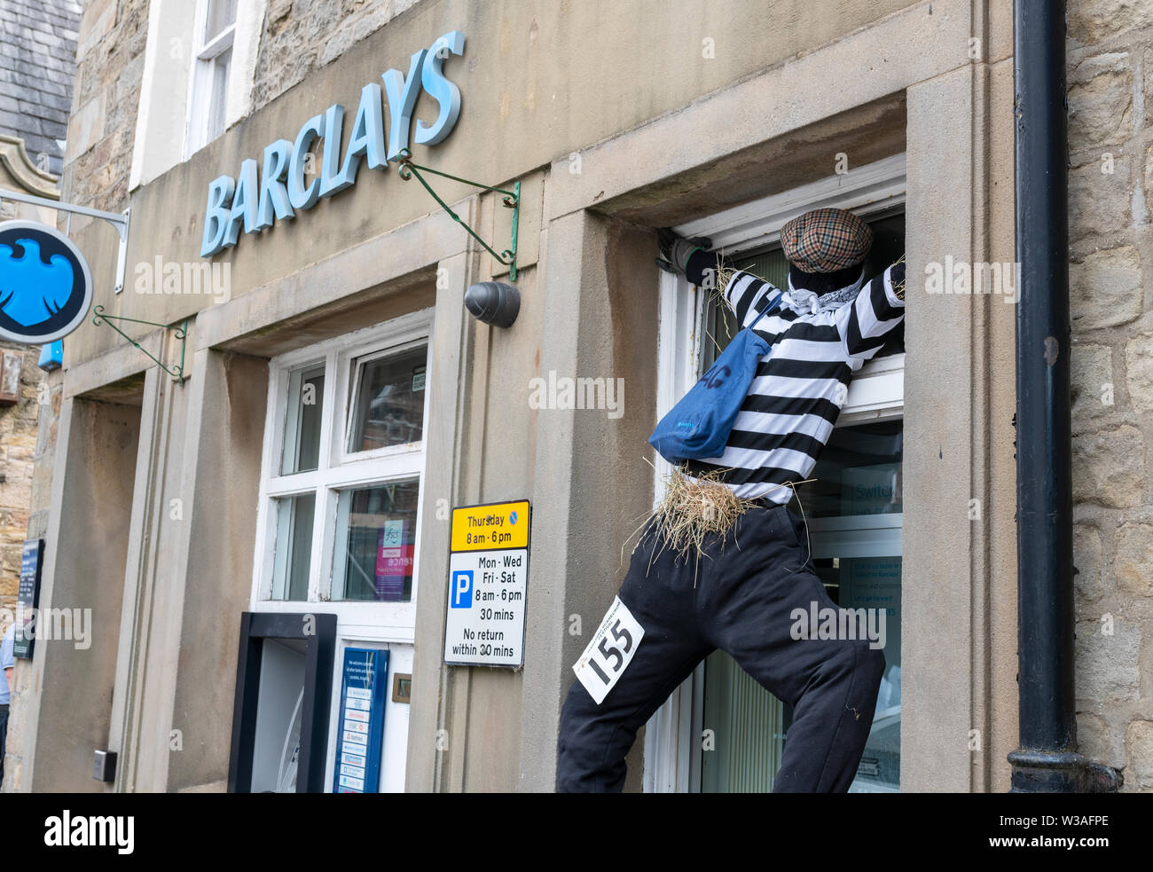 An exhibit at the Garstang Scarecrow Festival. A burglar breaking into a window of Barclays Bank Stock Photo
