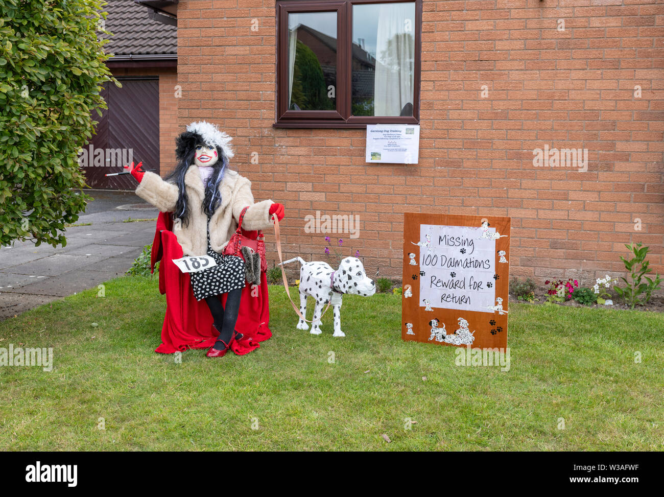 An exhibit at the Garstang Scarecrow Festival. Cruella De Vil and a Dalmatian dog Stock Photo