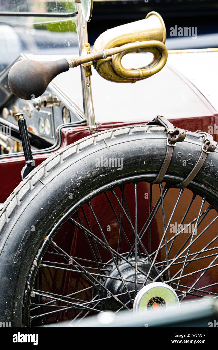 Close up of a vintage car with a spare spoked wheel and horn Classic cars at the Oakamoor Hill Climb, 13th July 2019, Oakamoor, Staffordshire, UK Stock Photo