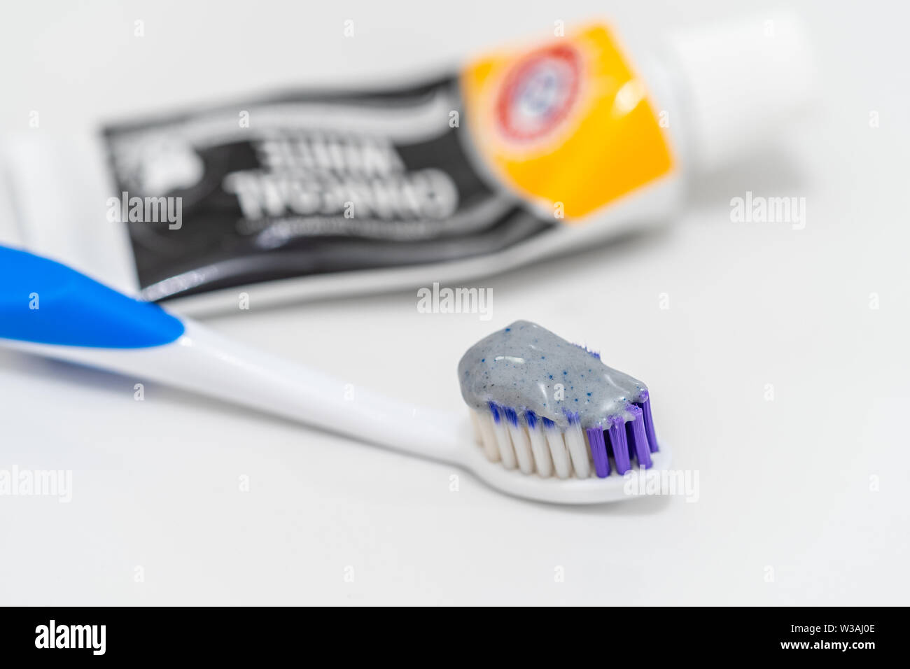 Whitening teeth with charcoal toorhpaste hires stock photography and