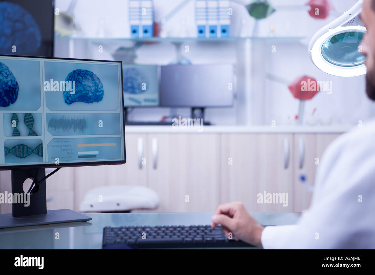 Photo of a brain x-ray examined by a young doctor. Control room in a hospital laboratory. Stock Photo