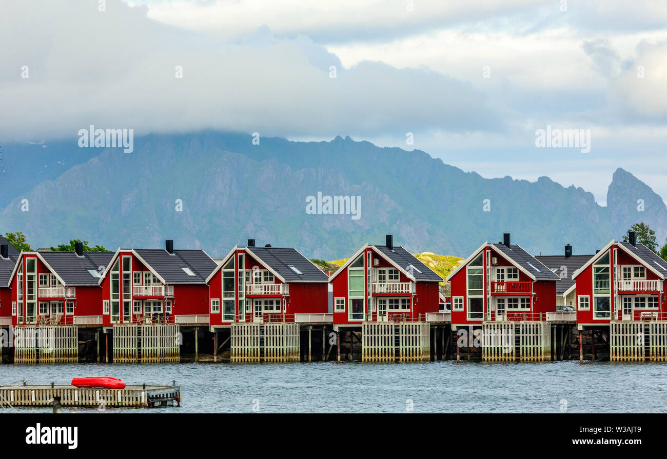Red norwegian fishing houses rorbu at pier in Svolvaer, Lototen islands, Austvagoya, Vagan Municipality, Nordland County, Norway Stock Photo