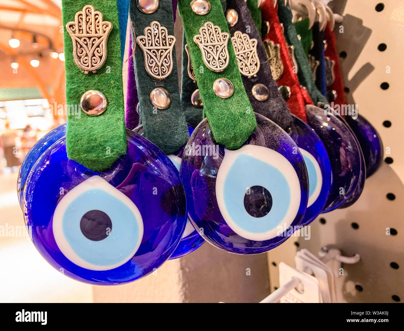 The evil eye Hamsa, a charm made to ward off the evil eye and protect the person wearing it. Traditional Muslim decoration in Turkey and Greece. Stock Photo