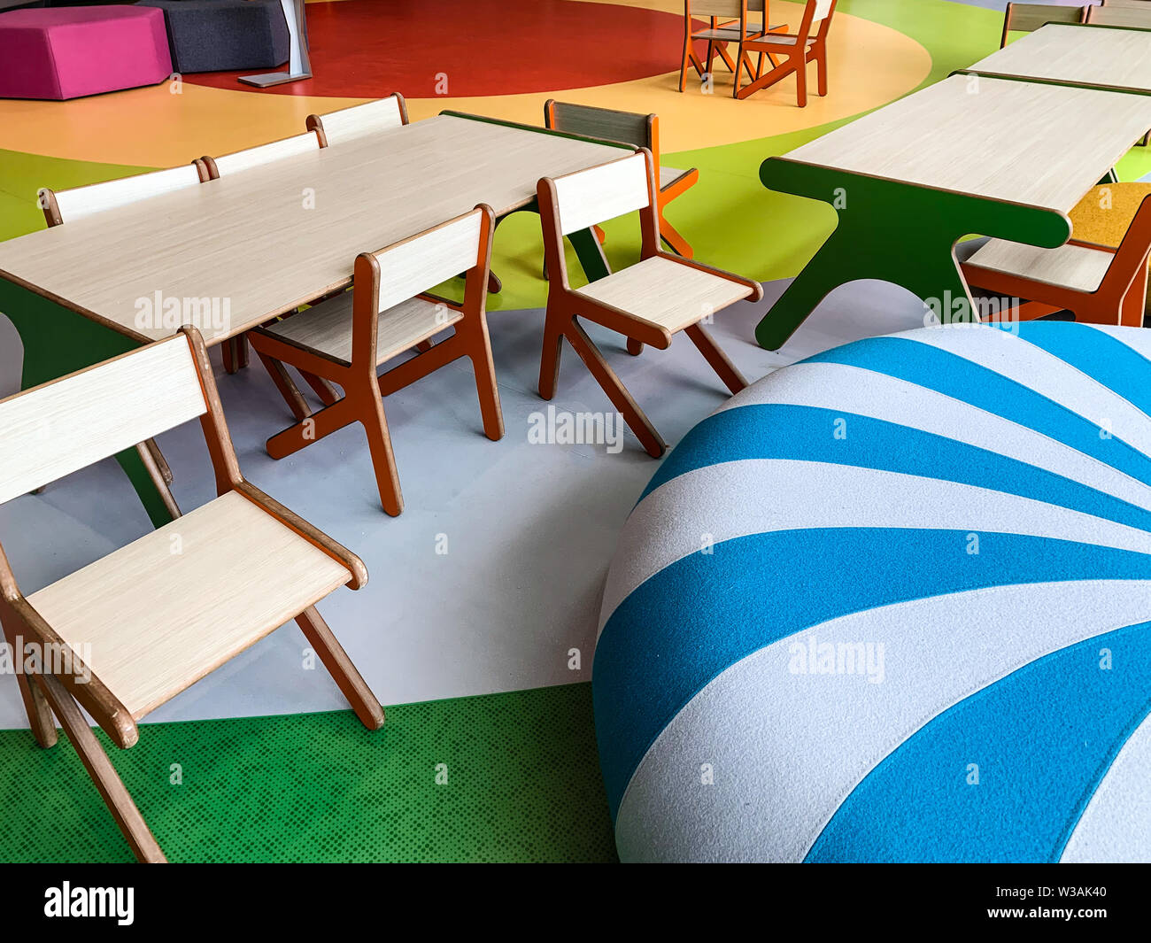 Modern and colorful playing area with chairs and tables for kids in a waiting room or a public terminal. Family friendly concept. Stock Photo