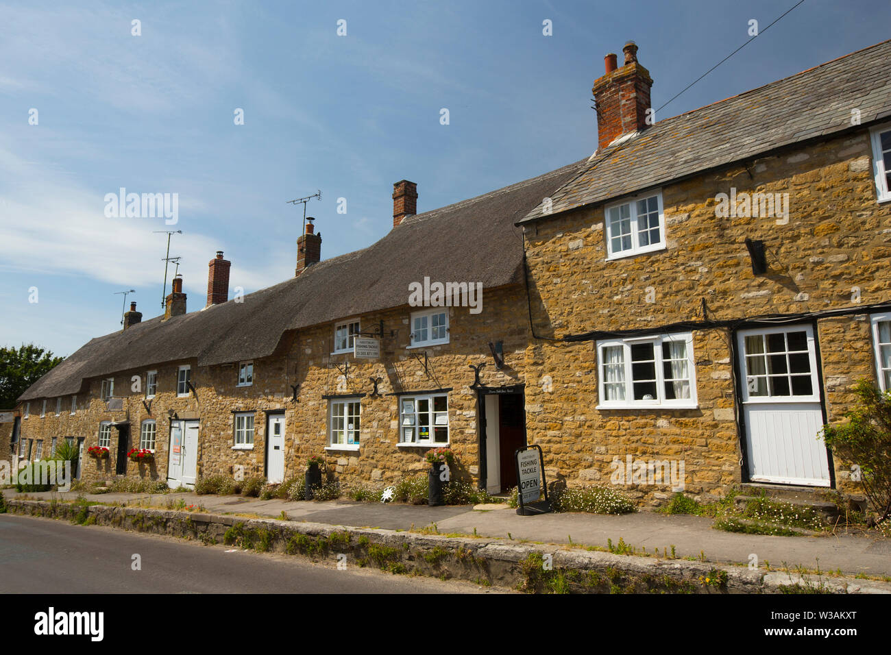 A view of the Abbotsbury Fishing Tackle shop and houses in the village of Abbotsbury close to