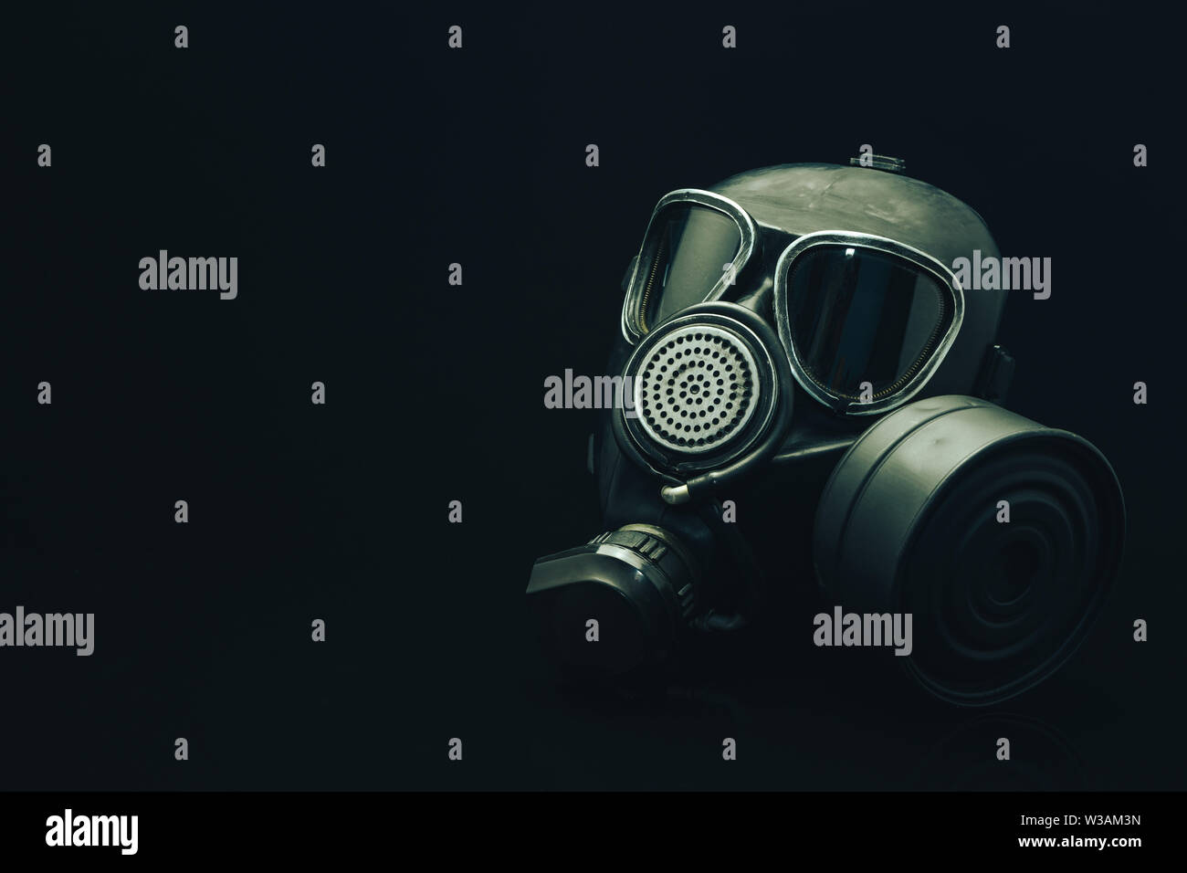 Gas mask on a black table and dark background Stock Photo - Alamy