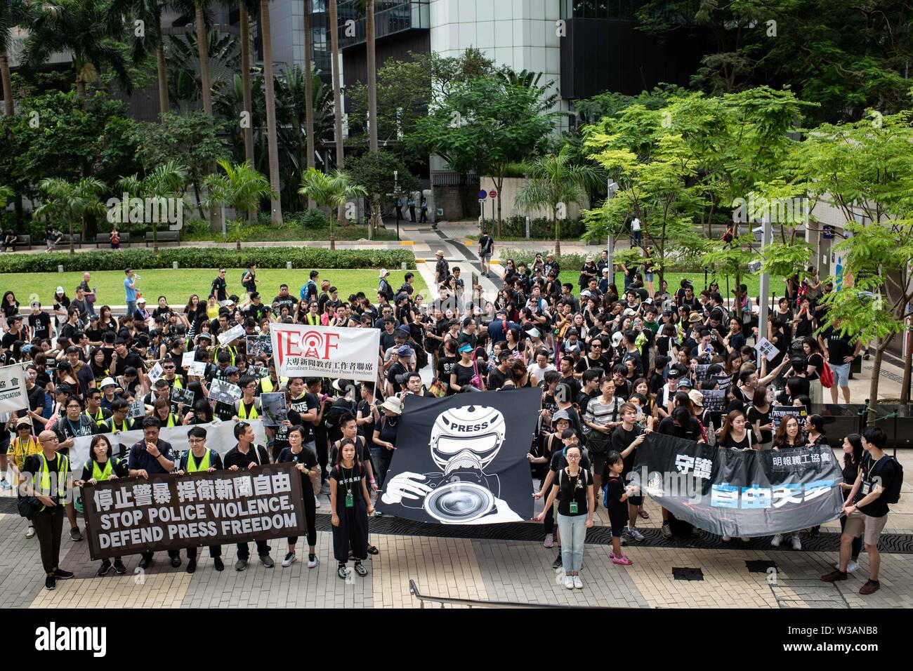Hong Kong, China. 14th July, 2019. Protesters hold banners during a march claiming for press freedom.Media groups and journalist trade unions held a “Stop Police Violence, Defend Press Freedom” silent march to express demands that police facilitates the work of news media and respect press freedom. The protest were called after media professionals suffered aggressions and were insulted by police officers while covering the protests against the extradition law to China. Credit: SOPA Images Limited/Alamy Live News Stock Photo
