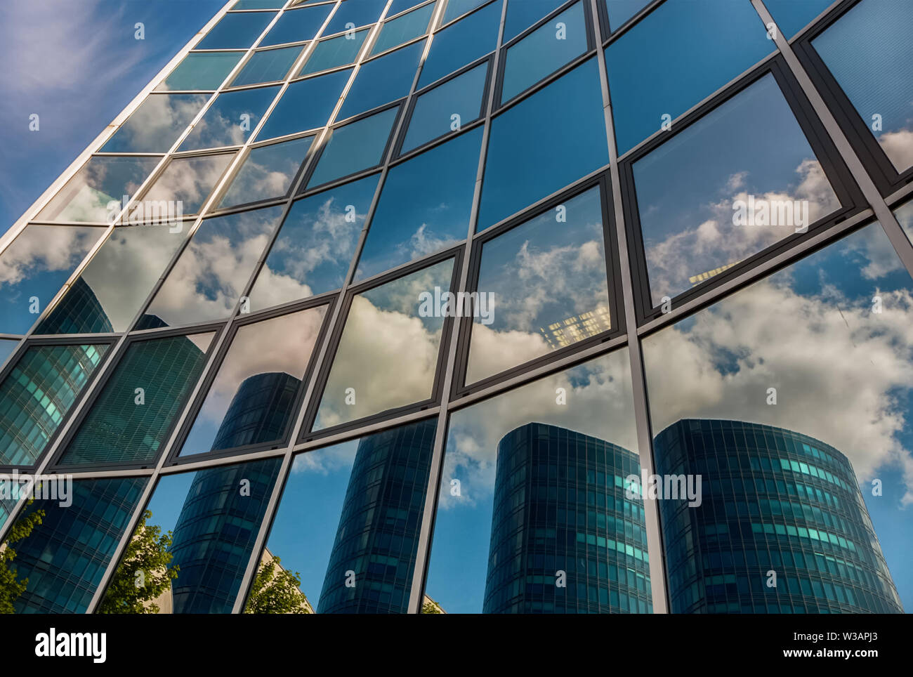 Reflections of clouds on glass facade of modern building hi-res stock ...