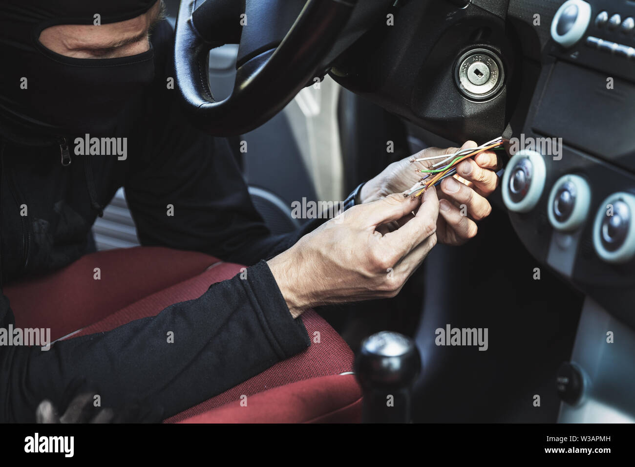 car hotwire - thief try to steal a vehicle by connecting ignition wires Stock Photo