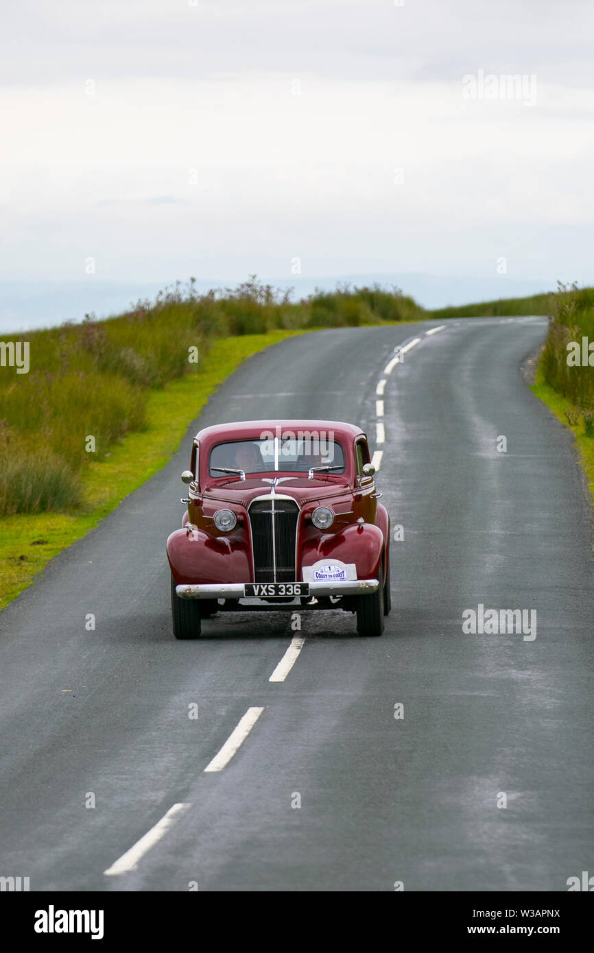 1937 30s pre-war Chevrolet maroon coupe at Scorton, Lancashire. Lancashire Car Club Rally Coast to Coast crosses the Trough of Bowland. 74 vintage, classic oldtimers, collectible, heritage, historics vehicles left Morecambe heading for a cross county journey over the Lancashire landscape. Stock Photo