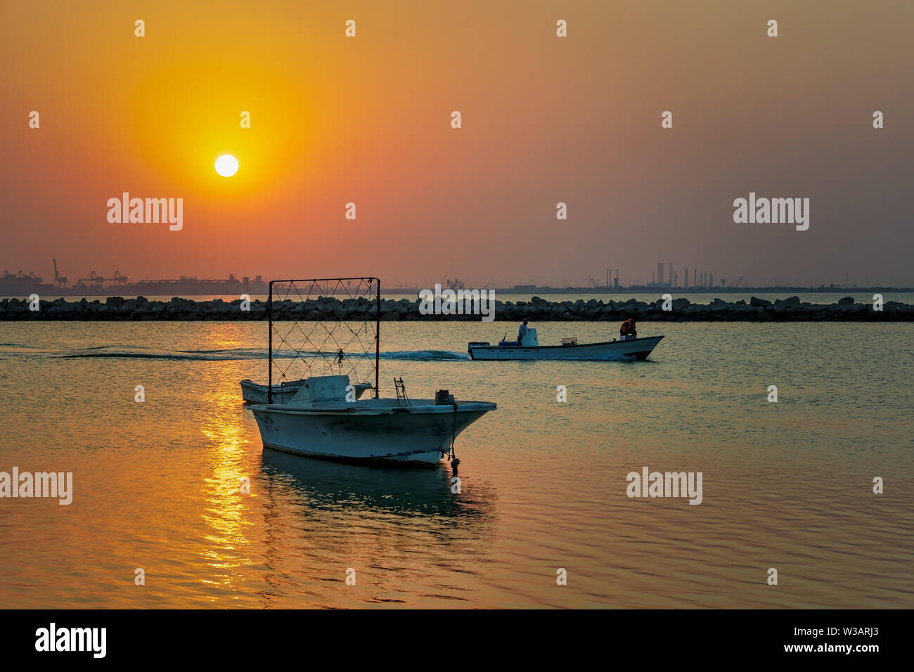 Beautiful Sunrise Boat in seaside with yellow sky. Dammam -Saudi Arabia Stock Photo